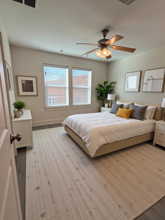 1601 Miriam Avenue, Unit 210 Austin, TX 78702 - Photo 12 of 15 Bedroom with ceiling fan and light wood finished floors