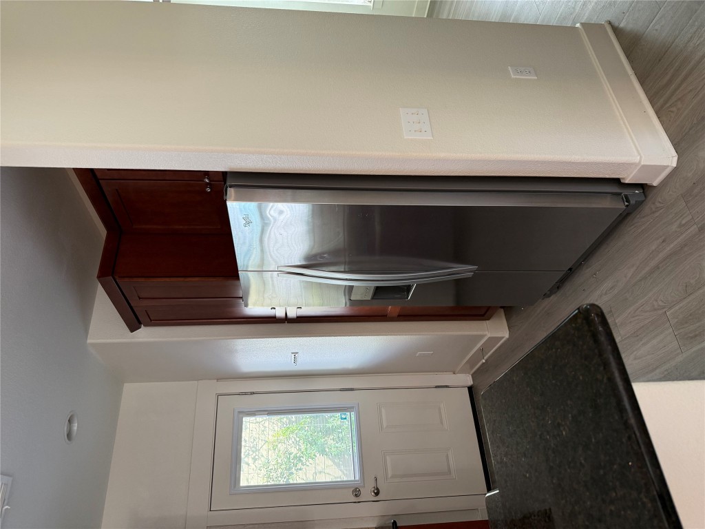 1601 Miriam Avenue, Unit 210 Austin, TX 78702 - Photo 7 of 15 Kitchen featuring stainless steel refrigerator with ice dispenser and light wood finished floors