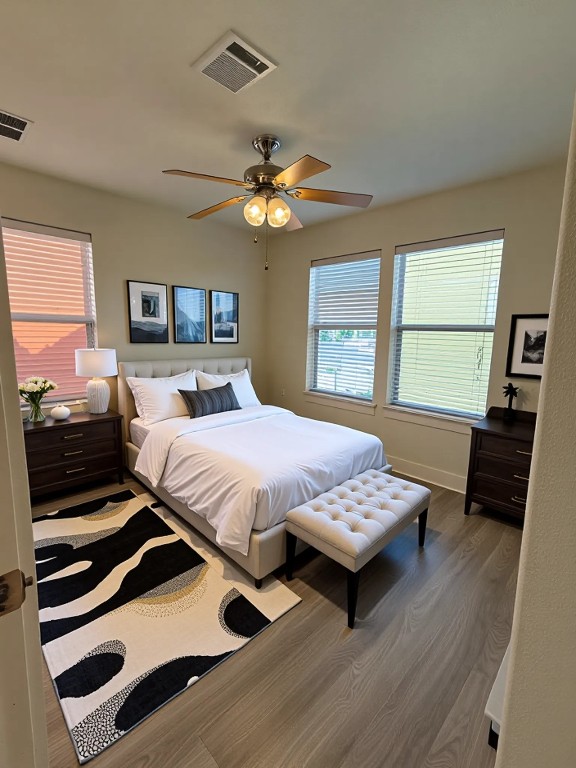 1601 Miriam Avenue, Unit 210 Austin, TX 78702 - Photo 10 of 15 Bedroom with wood finished floors, a ceiling fan, and multiple windows