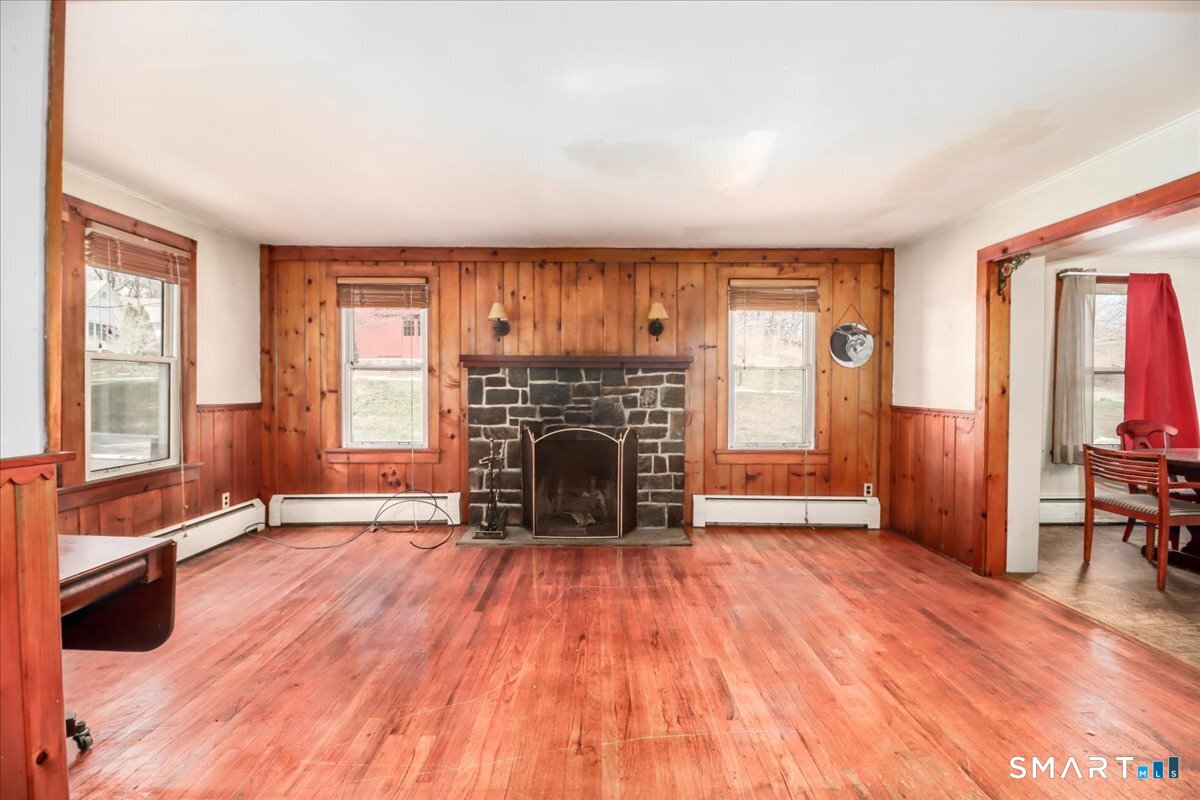 2 Sawmill Road Sherman, CT 06784 - Photo 15 of 40 a view of an empty room with a fireplace and a window
