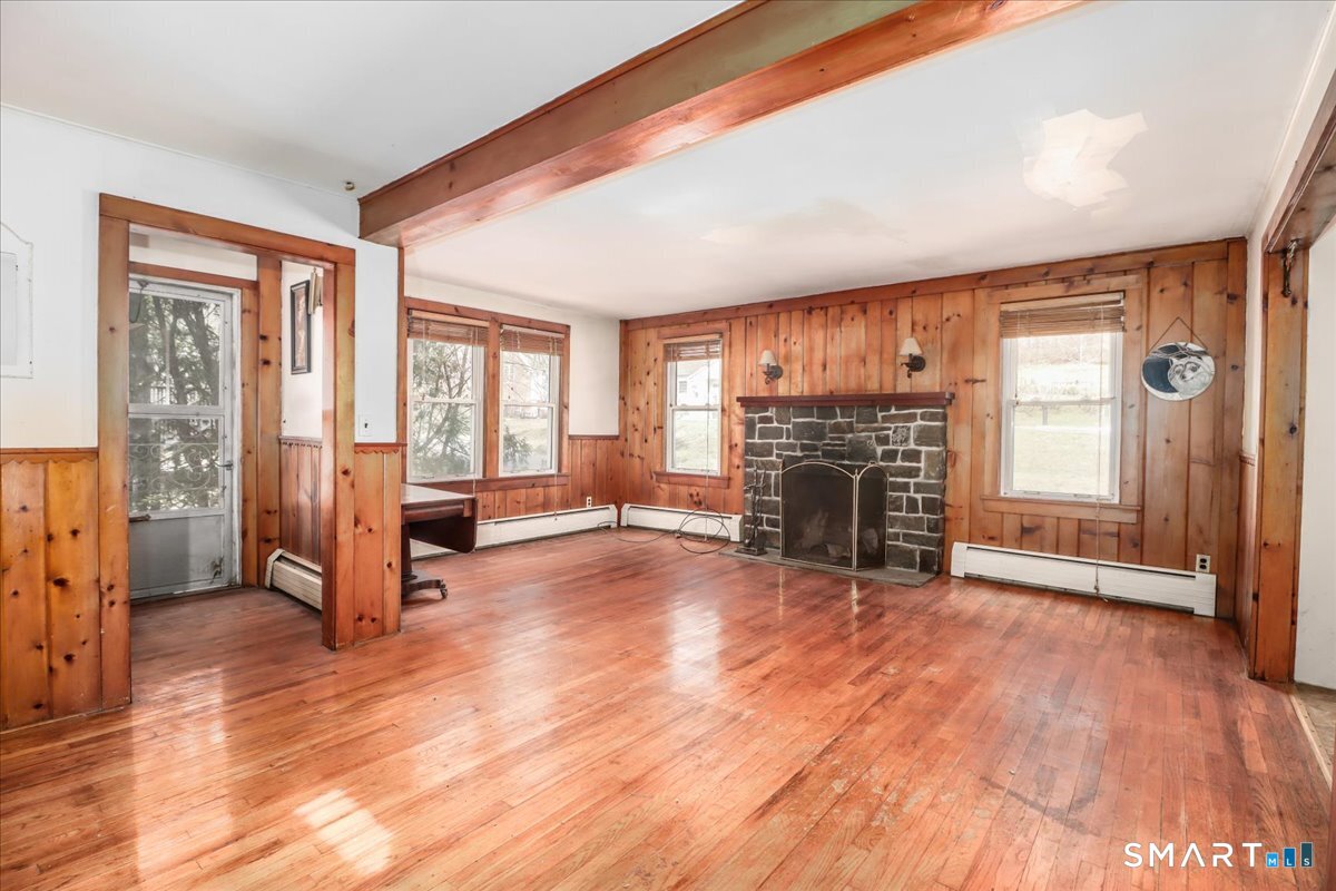 2 Sawmill Road Sherman, CT 06784 - Photo 16 of 40 a view of a livingroom with a fireplace and windows