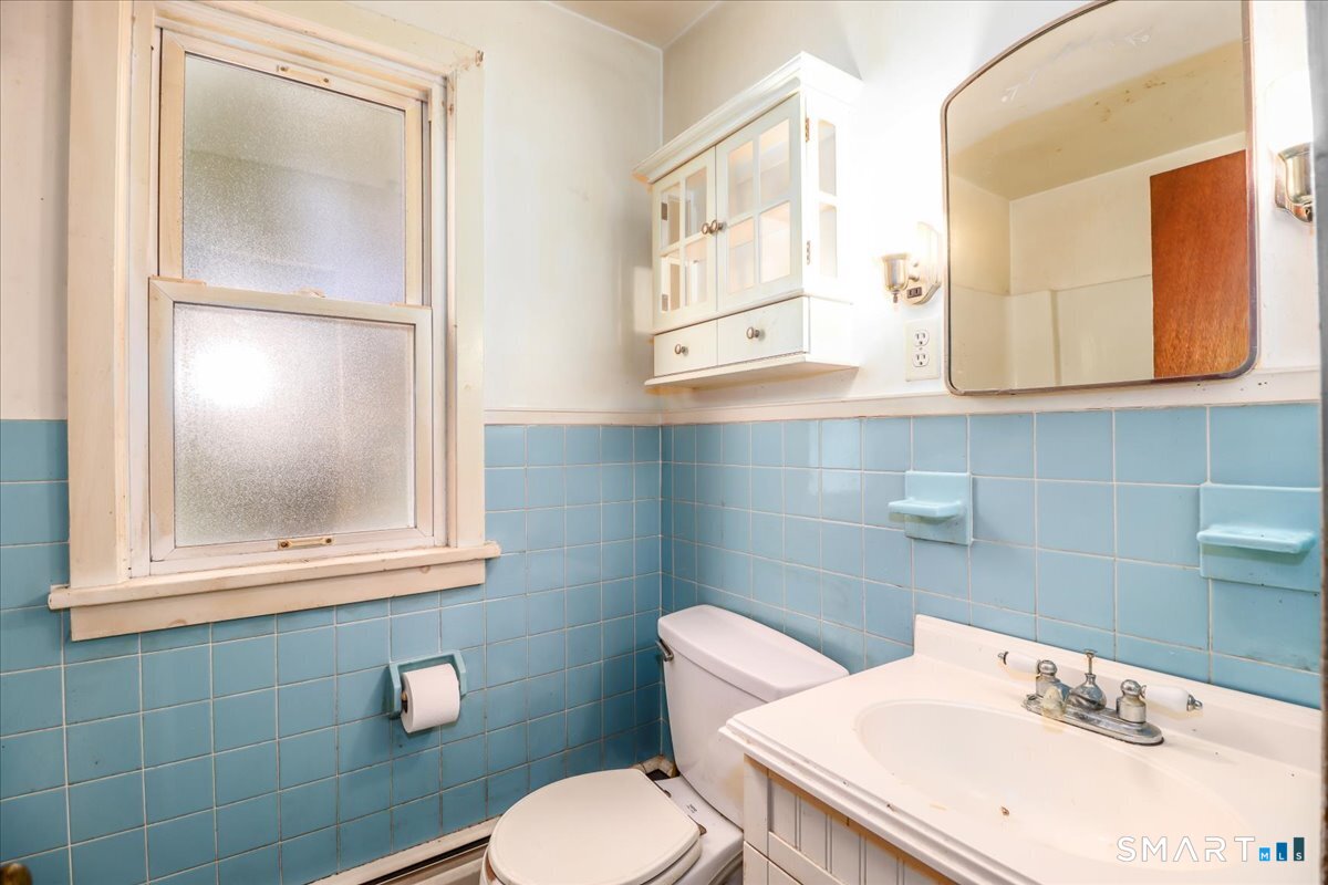 2 Sawmill Road Sherman, CT 06784 - Photo 18 of 40 a bathroom with a sink mirror and toilet