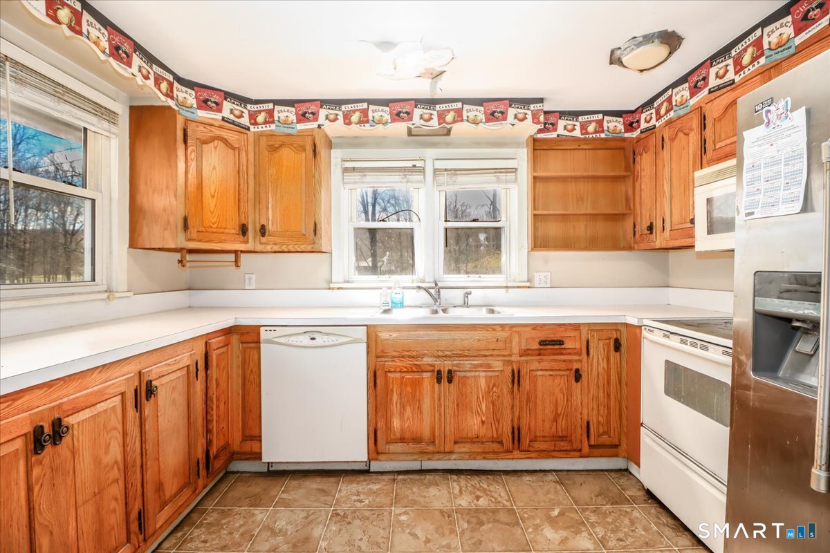 2 Sawmill Road Sherman, CT 06784 - Photo 21 of 40 a kitchen with stainless steel appliances granite countertop a sink stove and cabinets