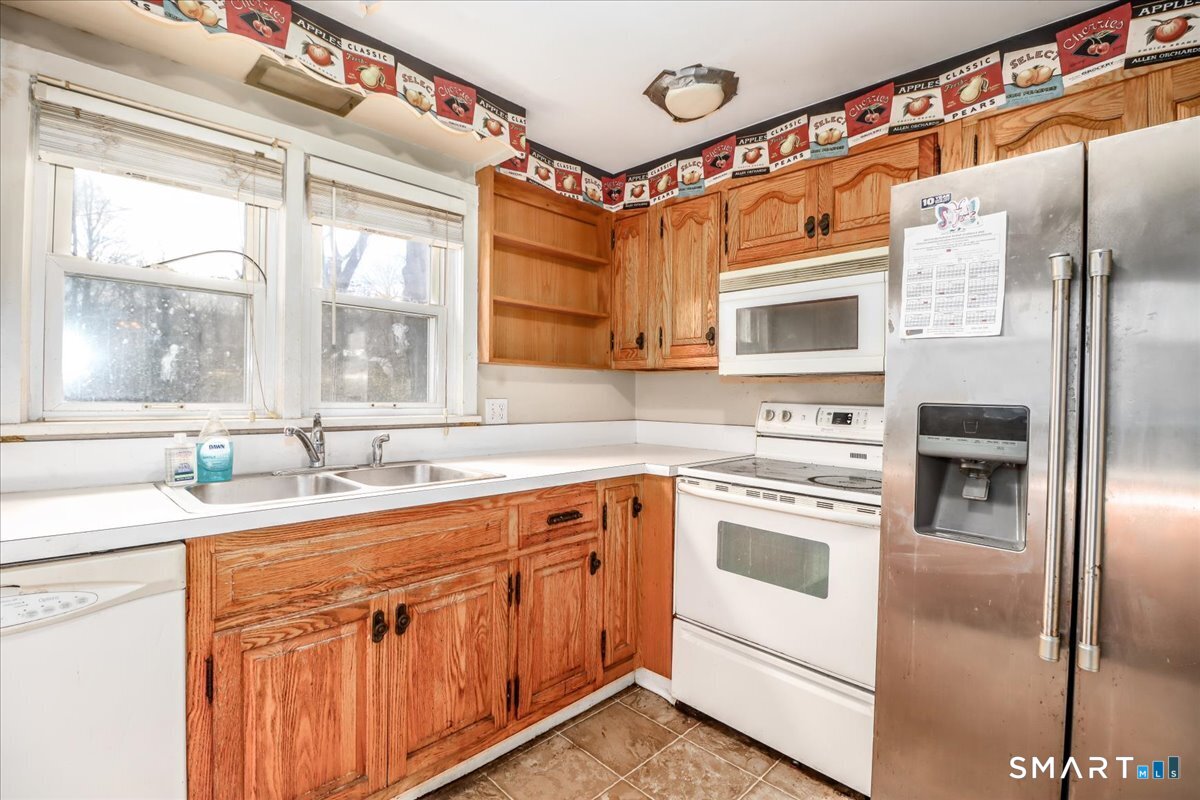 2 Sawmill Road Sherman, CT 06784 - Photo 22 of 40 a kitchen with stainless steel appliances granite countertop a sink and a refrigerator