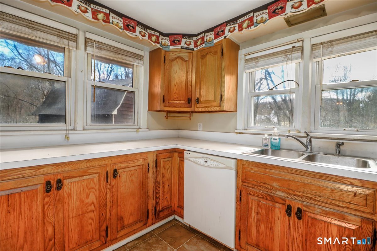2 Sawmill Road Sherman, CT 06784 - Photo 23 of 40 a kitchen with stainless steel appliances granite countertop a sink and a granite counter tops with a large window