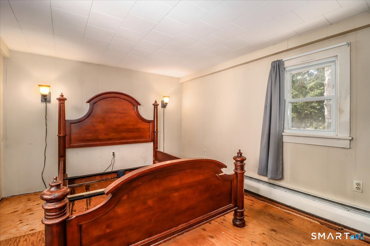 2 Sawmill Road Sherman, CT 06784 - Photo 24 of 40 a room with a bed and a window