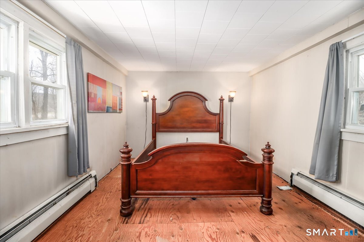 2 Sawmill Road Sherman, CT 06784 - Photo 25 of 40 a bedroom with a bed and a window