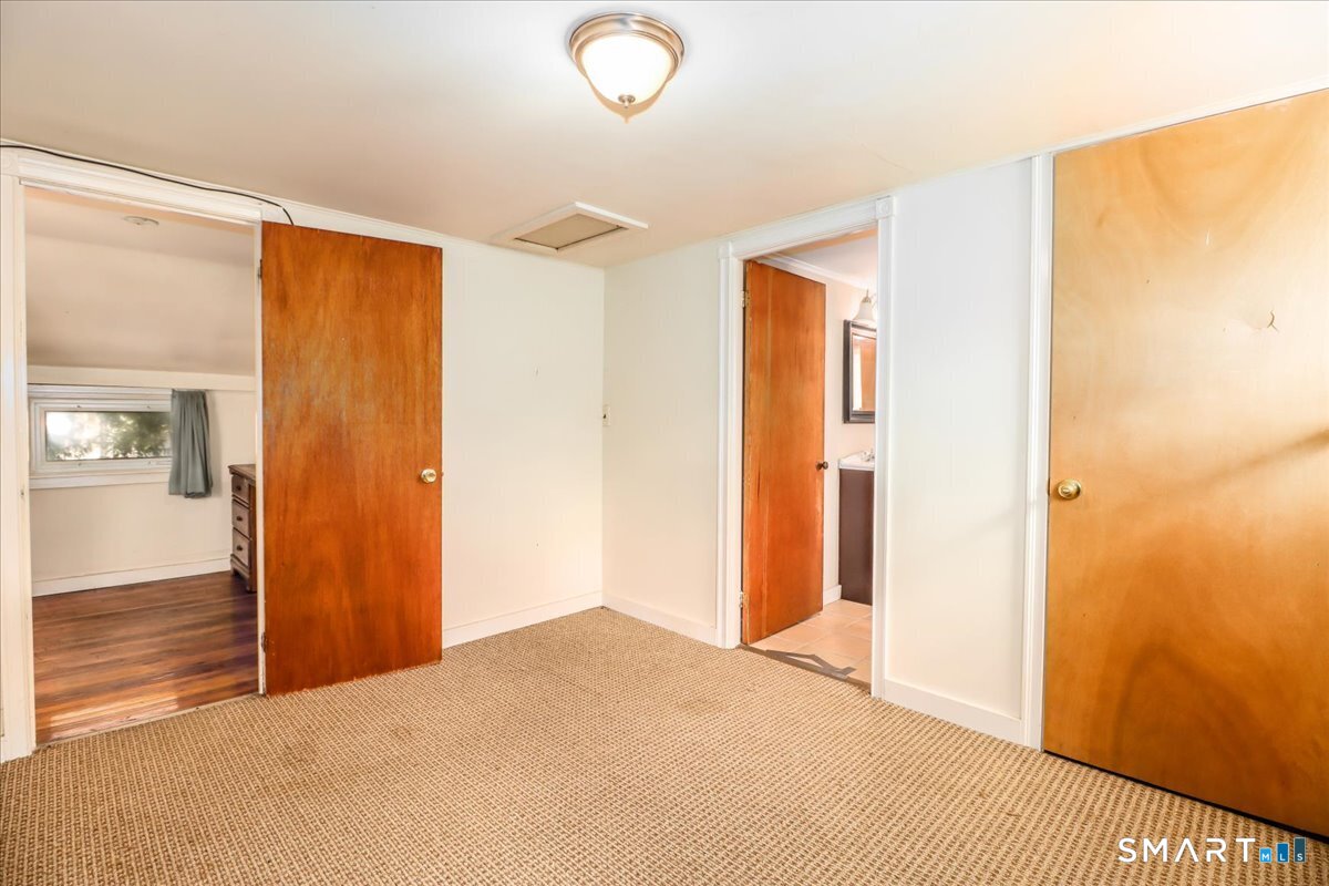 2 Sawmill Road Sherman, CT 06784 - Photo 28 of 40 a bedroom with a bed and wooden floor