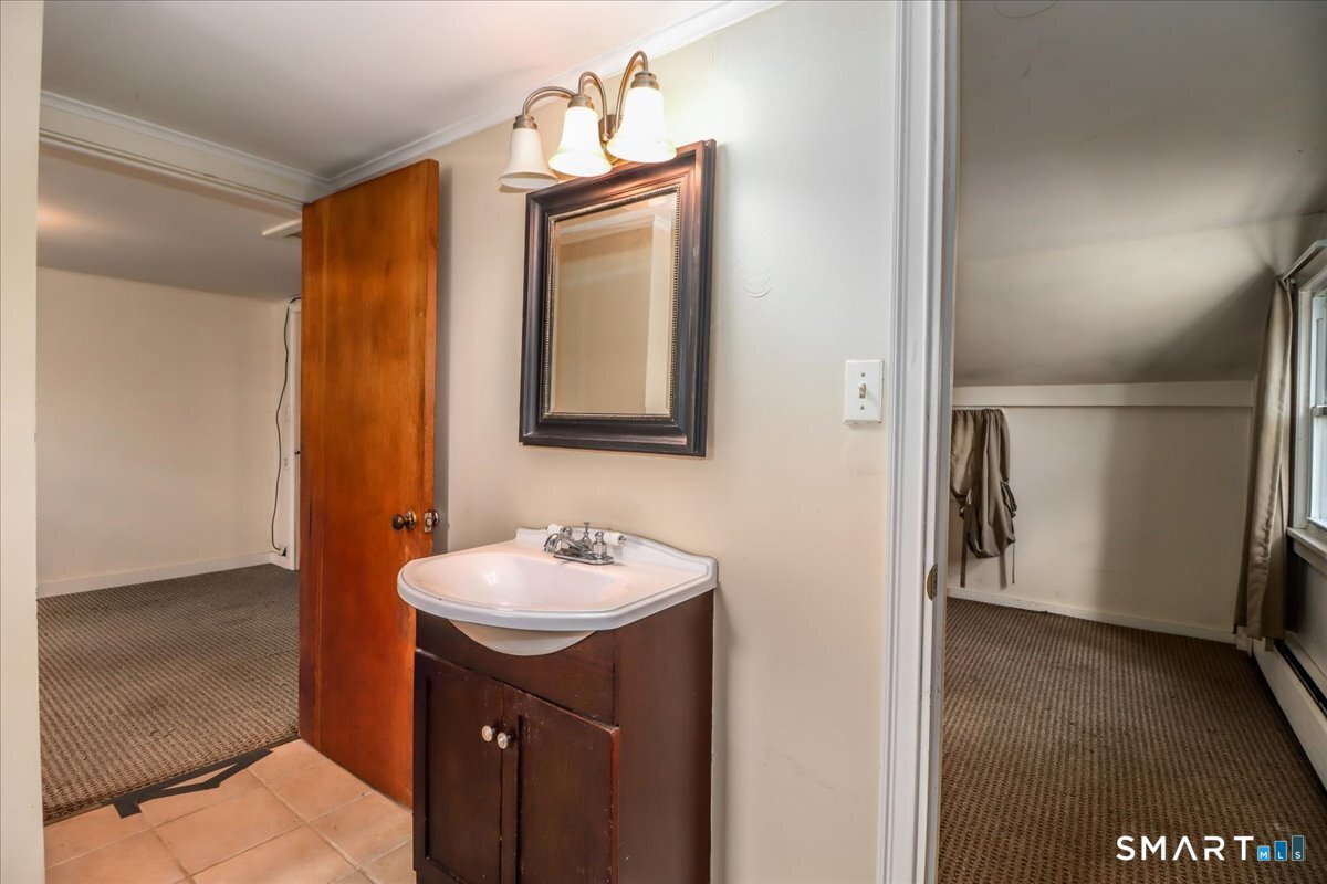 2 Sawmill Road Sherman, CT 06784 - Photo 29 of 40 a bathroom with a sink and a mirror
