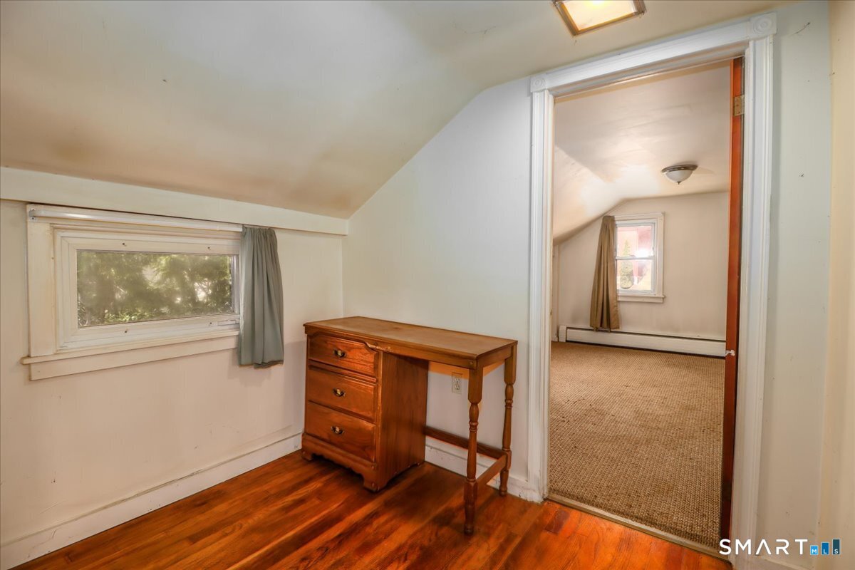 2 Sawmill Road Sherman, CT 06784 - Photo 33 of 40 a view of an empty room with wooden floor and a window
