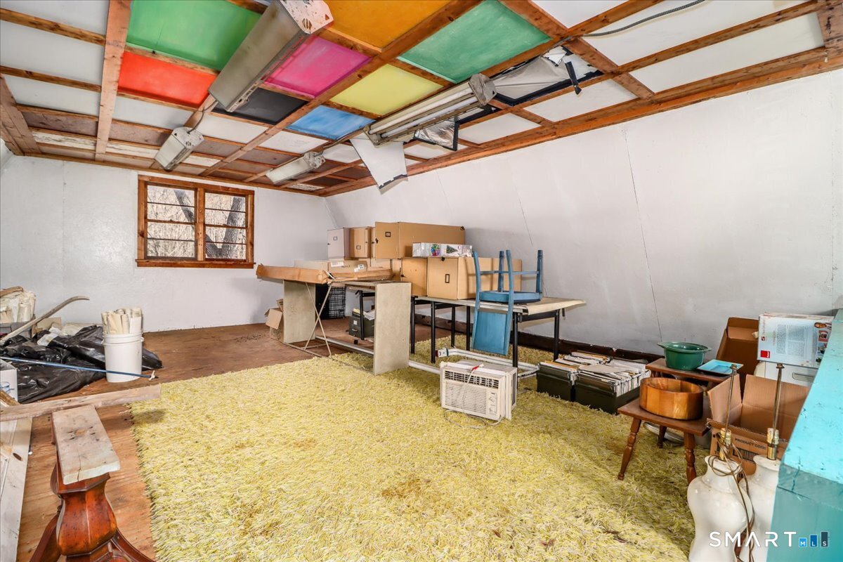 2 Sawmill Road Sherman, CT 06784 - Photo 36 of 40 a bed room with a bed and a chair