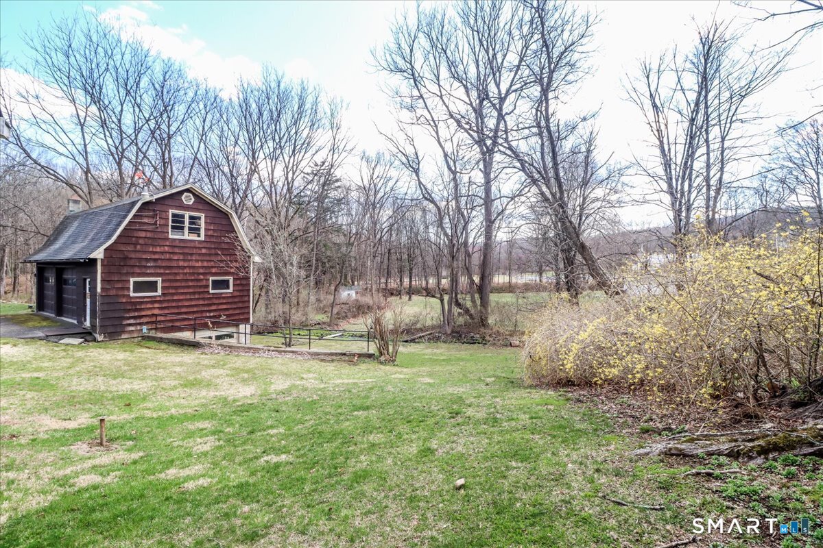 2 Sawmill Road Sherman, CT 06784 - Photo 5 of 40 a view of a house with a large trees and a yard