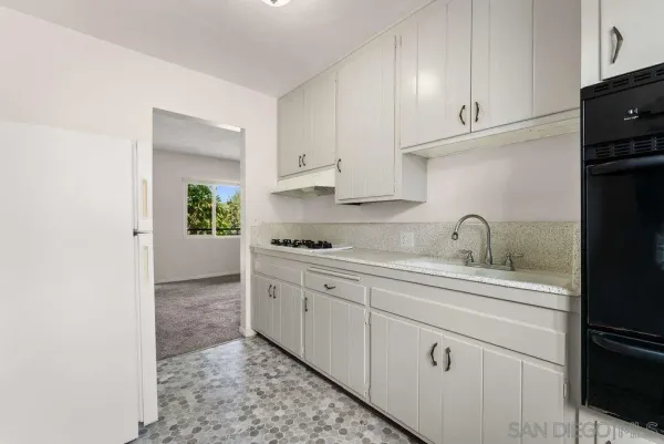 a kitchen with a sink and cabinets