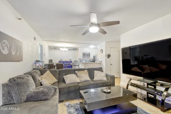 a living room with furniture and a flat screen tv