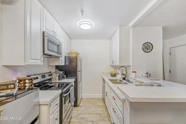 a kitchen that has a sink and a stove