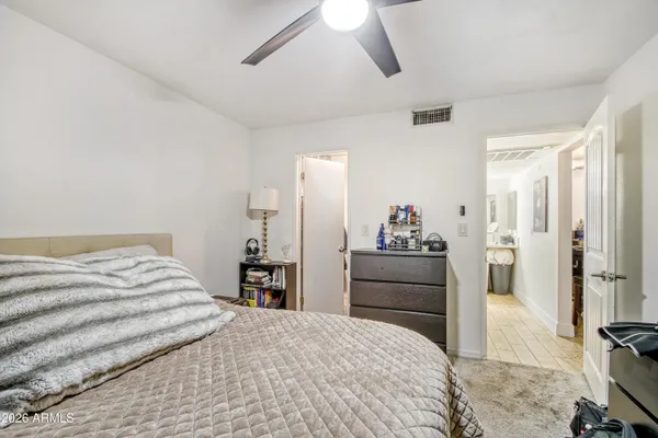 a bedroom with a bed and a dresser