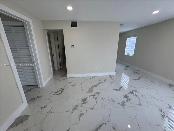 a view of empty room with windows