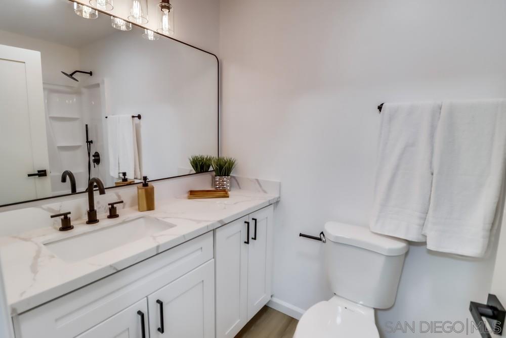 2821 Rosedale Way Spring Valley, CA 91977 - Photo 22 of 70 a bathroom with a sink and mirror with toilet