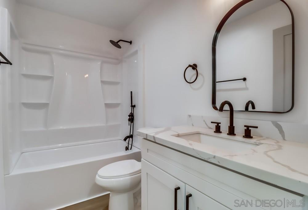 2821 Rosedale Way Spring Valley, CA 91977 - Photo 41 of 70 a bathroom with a sink a toilet and a mirror
