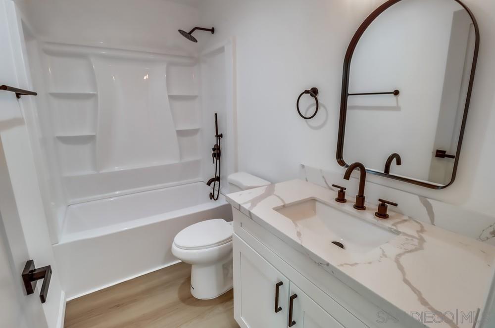 2821 Rosedale Way Spring Valley, CA 91977 - Photo 44 of 70 a bathroom with a sink a toilet and a mirror