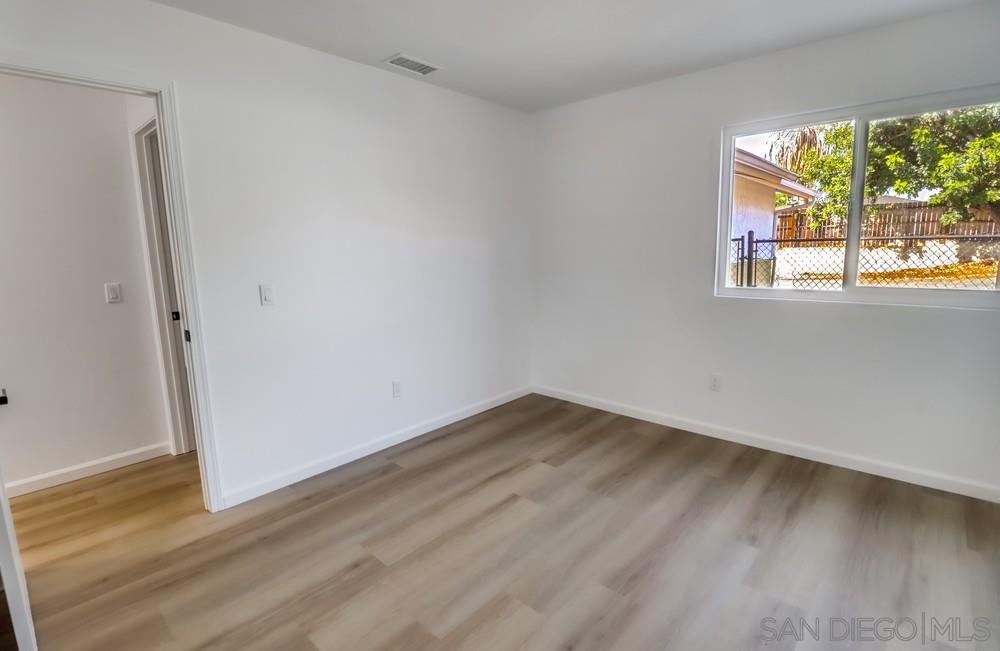 2821 Rosedale Way Spring Valley, CA 91977 - Photo 50 of 70 a view of an empty room with wooden floor and a window