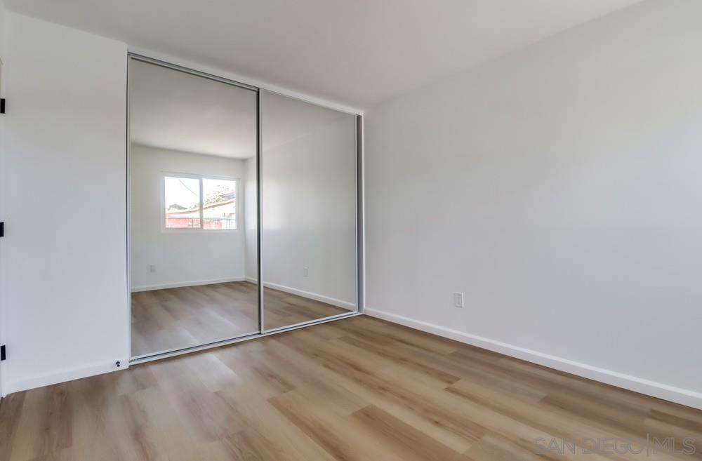 2821 Rosedale Way Spring Valley, CA 91977 - Photo 69 of 70 an empty room with wooden floor and mirror