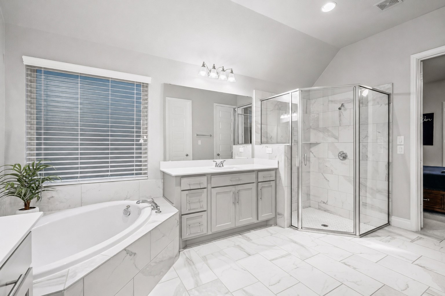 29118 Lantana Ridge Court Fulshear, TX 77441 - Photo 16 of 29 Take in another view of the primary bathroom, featuring a spacious tiled walk-in shower and recessed lighting that combines practicality with elegant design.