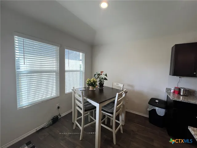 a dining room with furniture and wooden floor