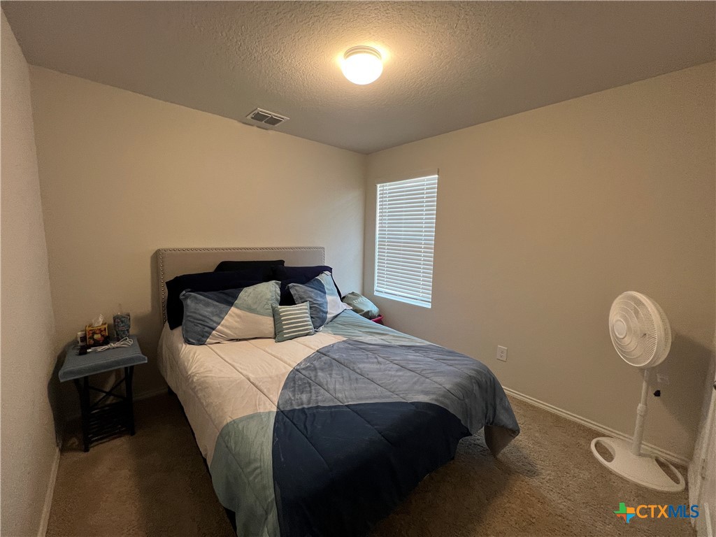 809 Margay Loop Seguin, TX 78155 - Photo 6 of 20 a bedroom with a bed and a window