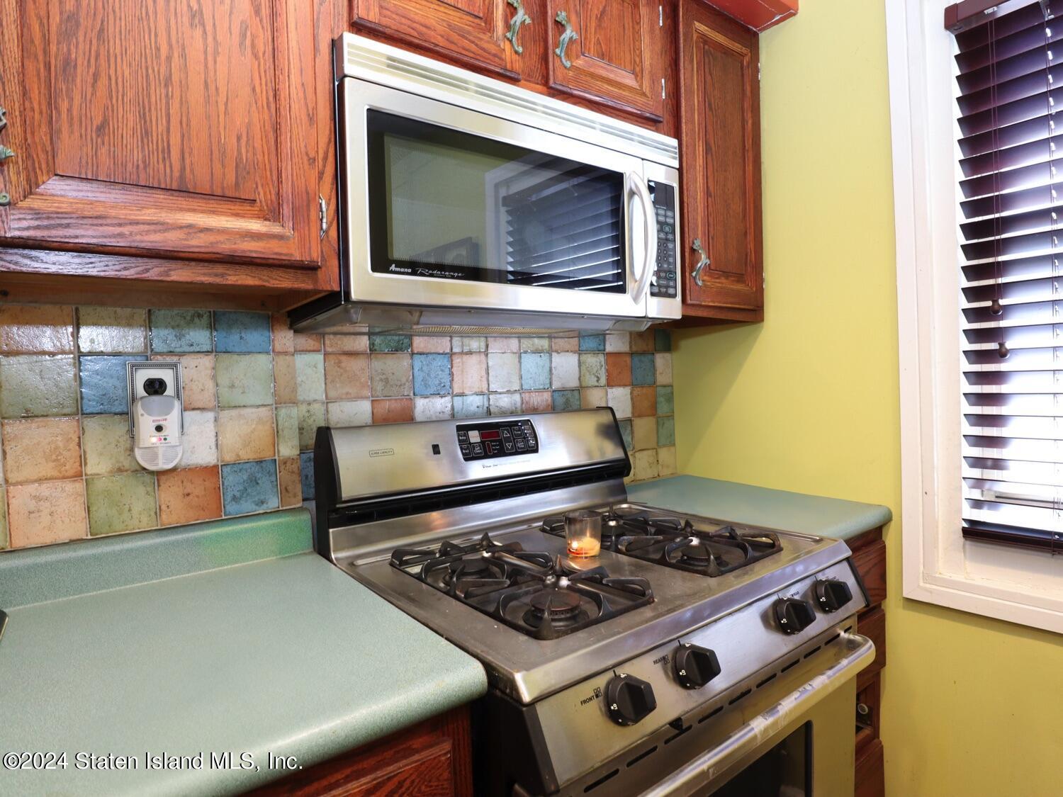 166 Arlo Road, Unit A Staten Island, NY 10301 - Photo 11 of 21 a stove top oven sitting inside of a kitchen