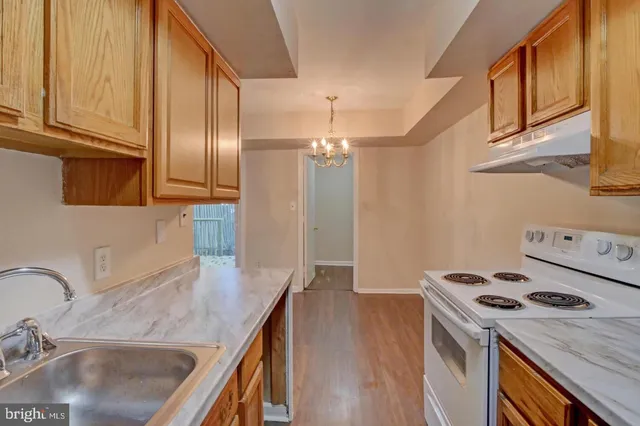 a kitchen with a sink a stove and cabinets