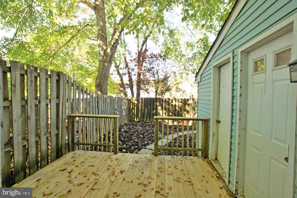 a view of balcony with wooden fence and floor