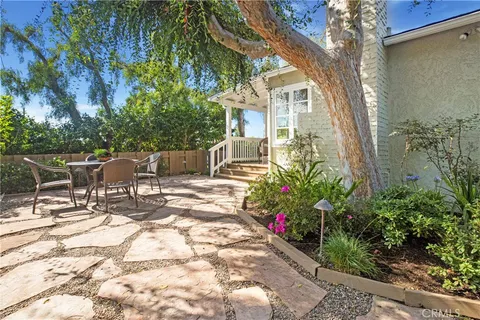 a view of a house with backyard and sitting area