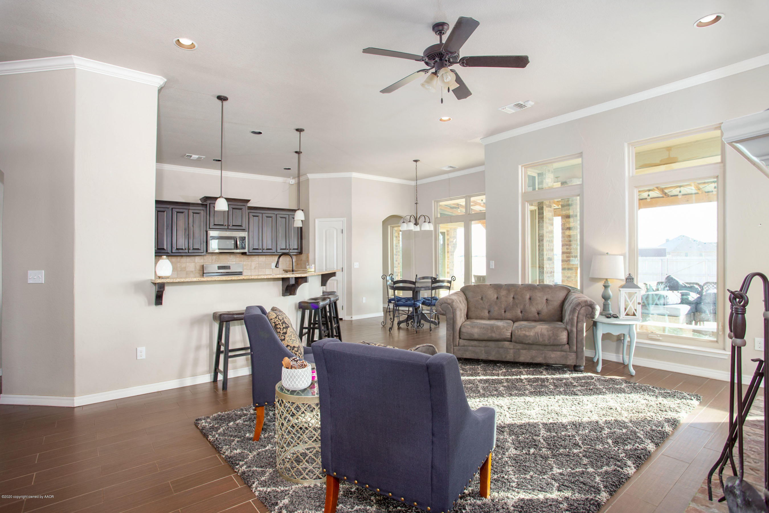 14901 Helium Road Amarillo, TX 79119 - Photo 4 of 30 a living room with furniture wooden floor and a view of kitchen