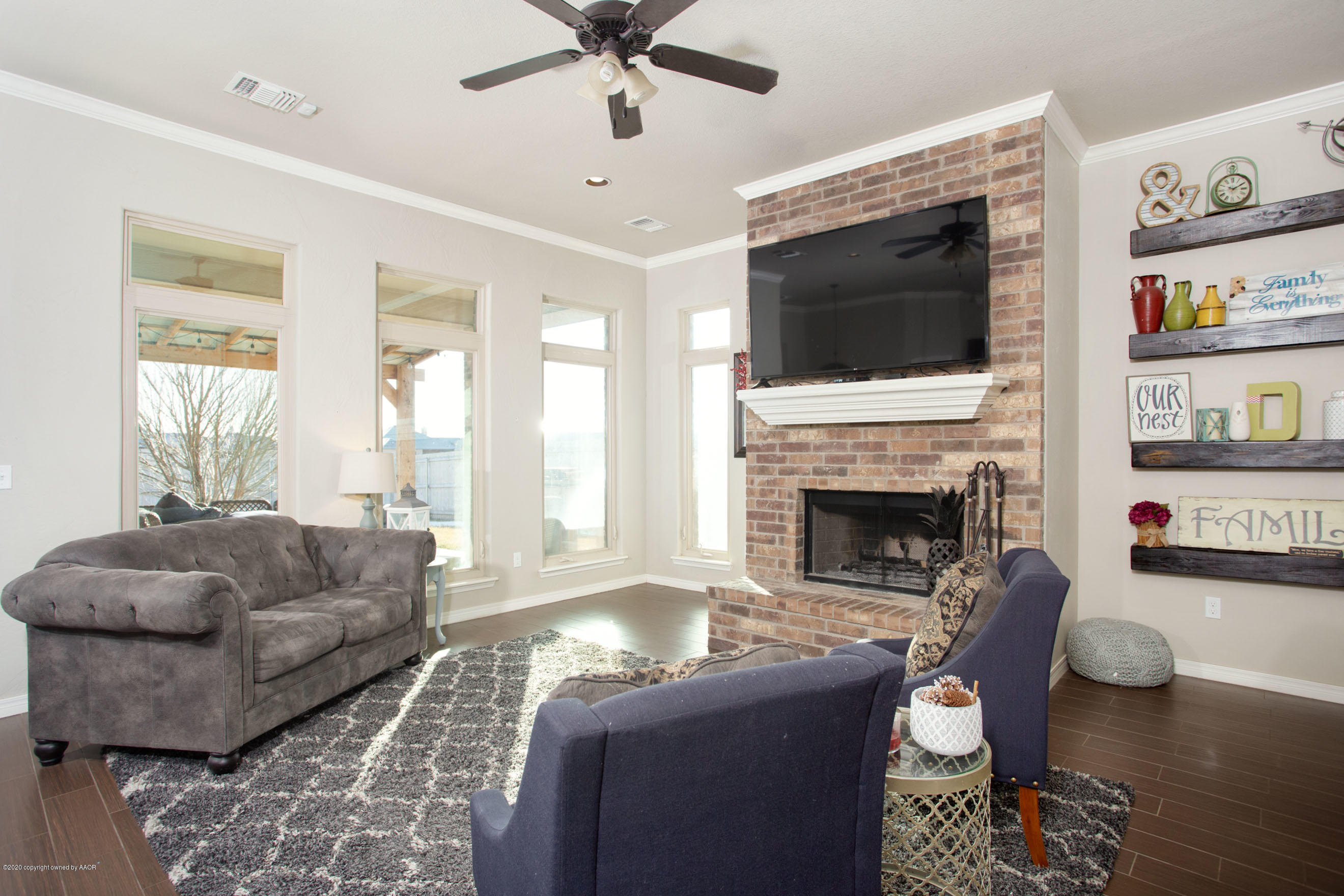 14901 Helium Road Amarillo, TX 79119 - Photo 5 of 30 a living room with furniture a flat screen tv and a fireplace