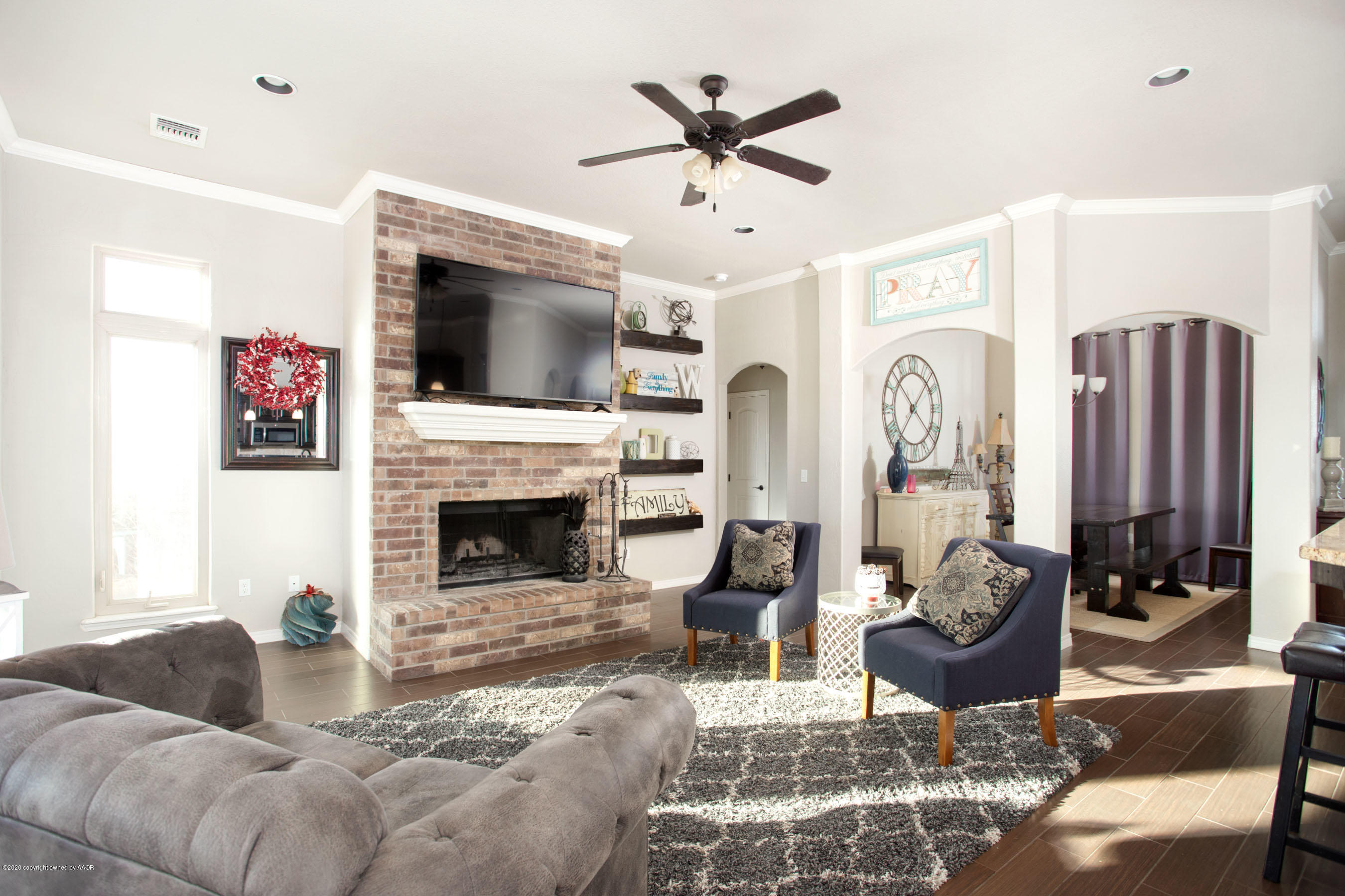 14901 Helium Road Amarillo, TX 79119 - Photo 8 of 30 a living room with furniture a fireplace and a flat screen tv