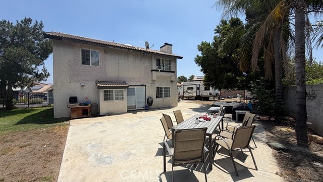 2478 KOA Drive Rialto, CA 92377 - Photo 12 of 18 a view of a patio with table and chairs and a barbeque with potted plants