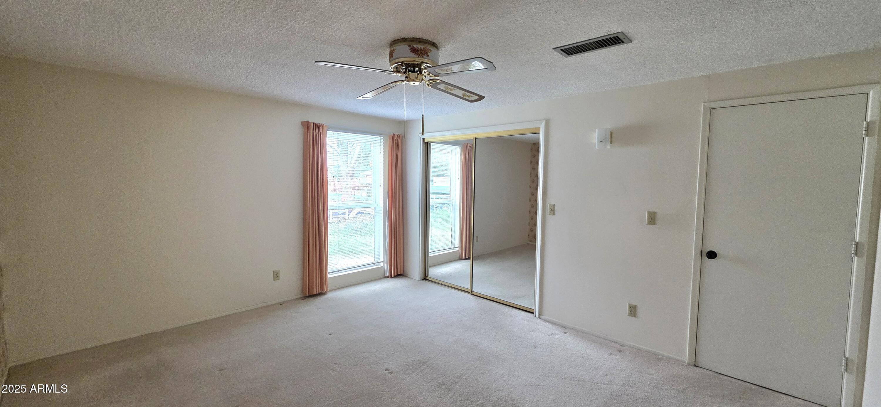 302 North Sage Street Pearce, AZ 85625 - Photo 19 of 38 a view of empty room with a ceiling fan