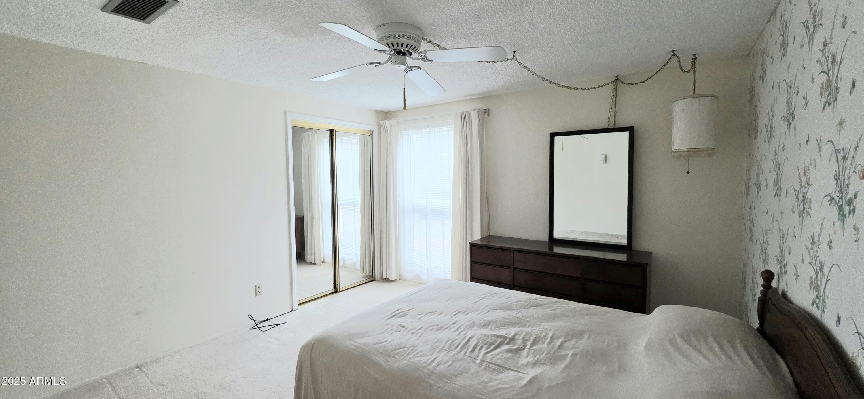 302 North Sage Street Pearce, AZ 85625 - Photo 23 of 38 a bedroom with a bed and a mirror