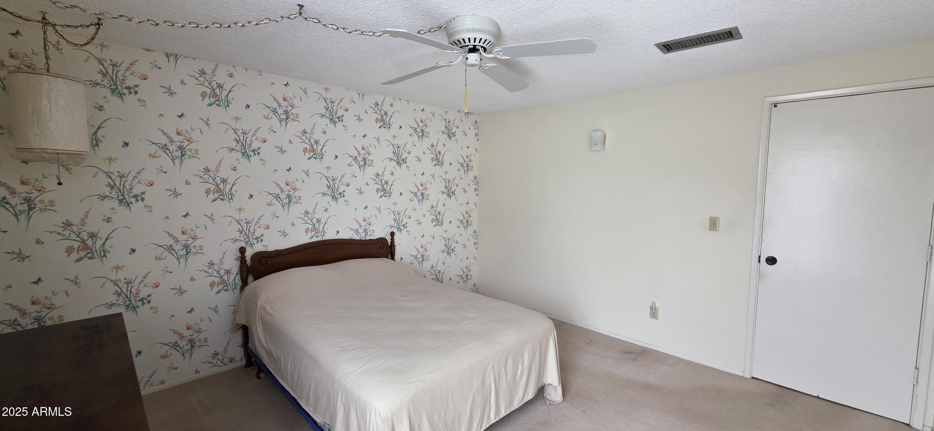 302 North Sage Street Pearce, AZ 85625 - Photo 24 of 38 a bedroom with a bed and a ceiling fan