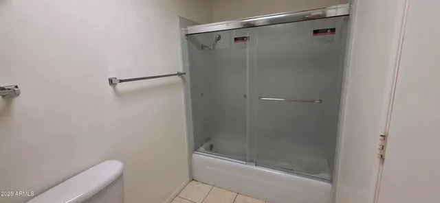 a view of a livingroom with a flat furniture tv and a window