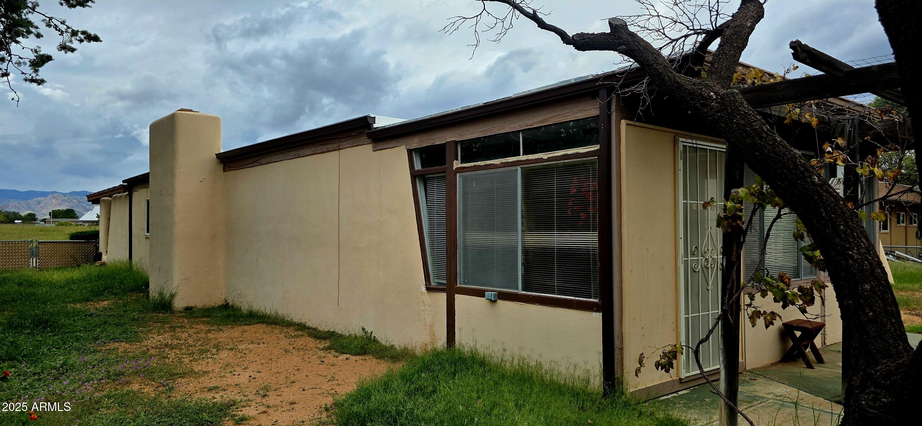 302 North Sage Street Pearce, AZ 85625 - Photo 37 of 38 a backyard of a house with barbeque oven table and chairs
