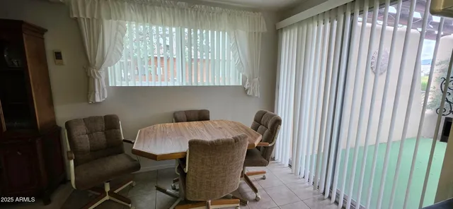a view of a dining room with furniture and a window