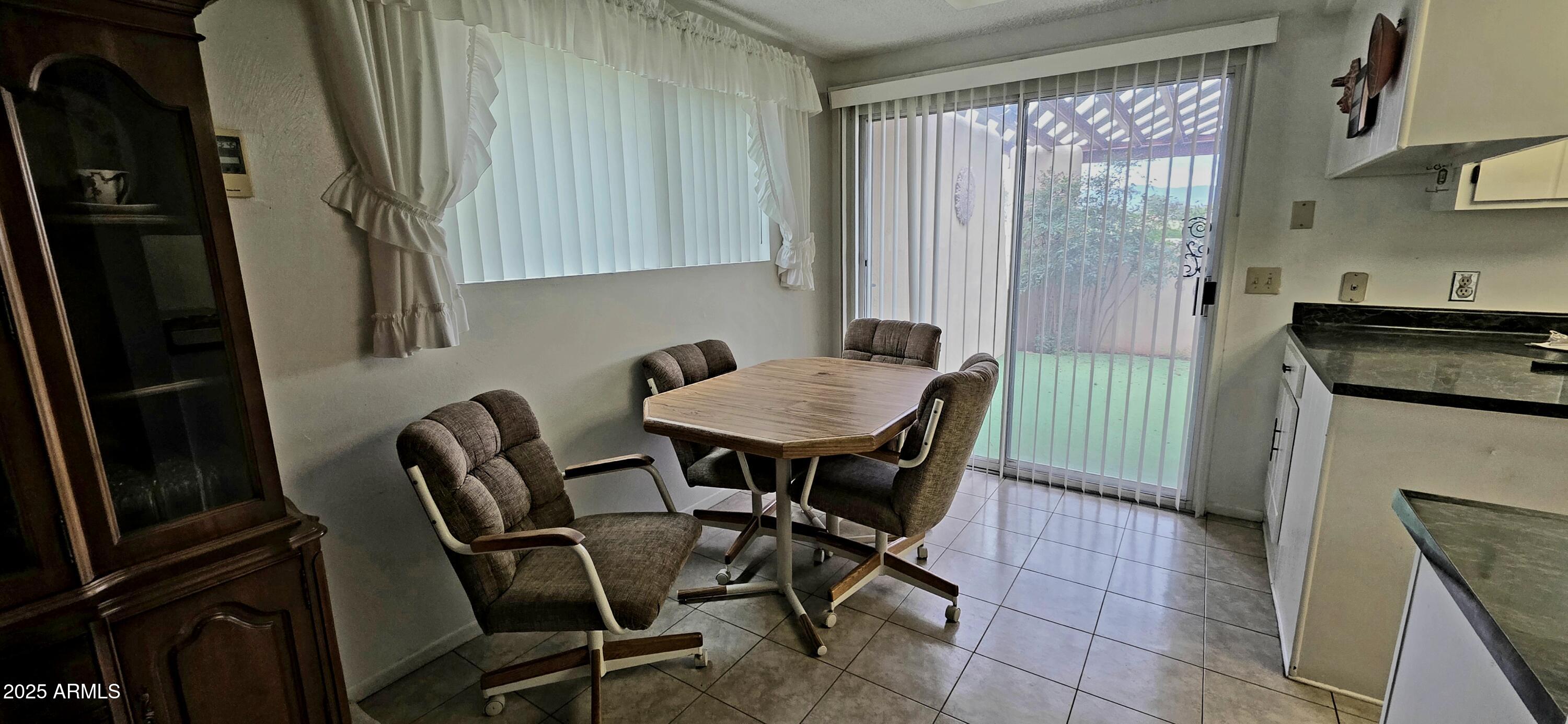 302 North Sage Street Pearce, AZ 85625 - Photo 10 of 38 a view of a dining room with furniture and a window