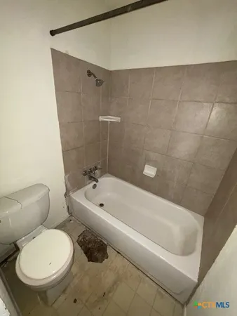 a bathroom with a toilet and a bathtub