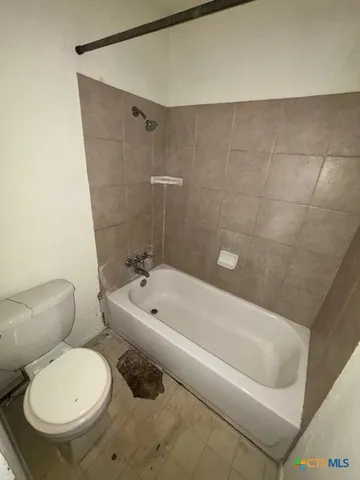 a bathroom with a toilet and a bathtub