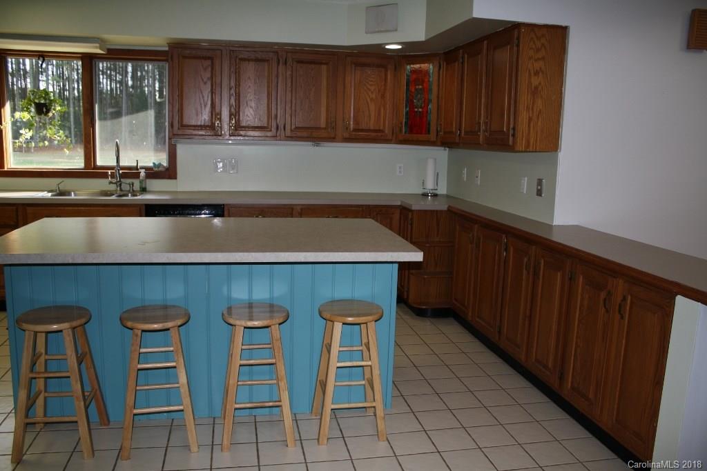 15850 Short Cut Road Gold Hill, NC 28071 - Photo 14 of 18 a kitchen with a sink cabinets and window