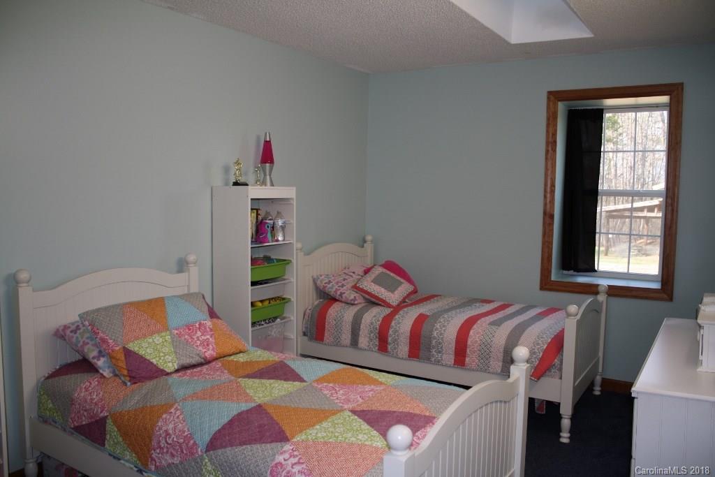 15850 Short Cut Road Gold Hill, NC 28071 - Photo 15 of 18 a bedroom with two beds and a window