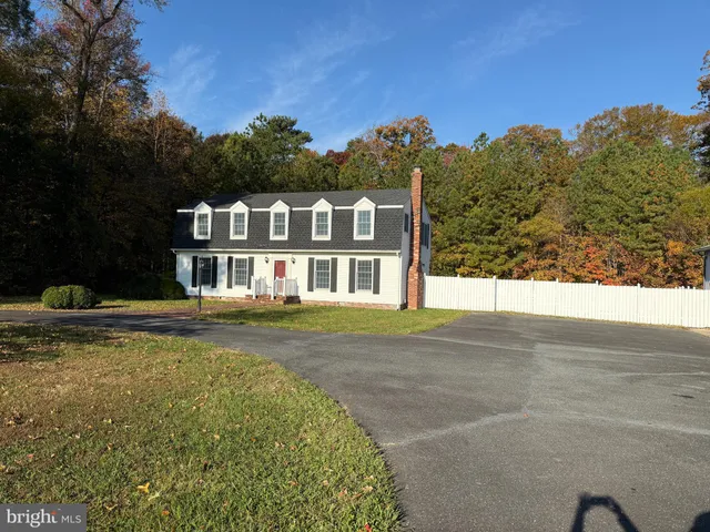 a front view of a house with a garden and swimming pool