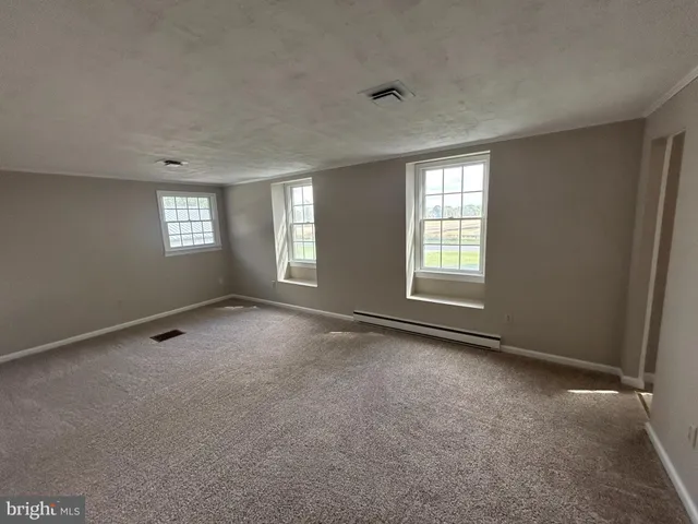 a view of an empty room with windows